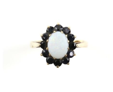 Vintage opal and sapphire cluster ring, central oval cabochon cut opal, set within a sapphire border, mounted in 9 ct, hallma