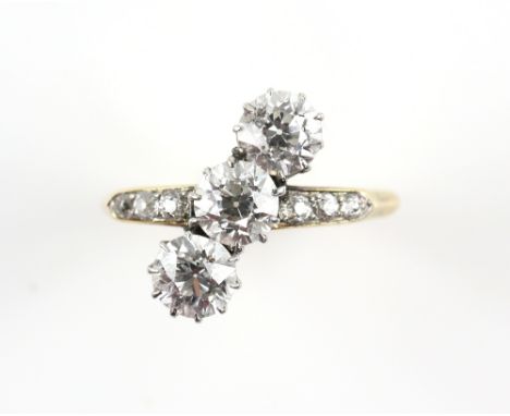Edwardian trilogy ring, set with old cut diamonds and diamond set shoulders, estimated total diamond weight 2.38 carats, moun