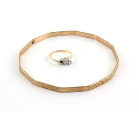 Three stone diamond ring, in 18 ct gold, centre stone estimated at 0.25 carat, ring size L and a flapper girl arm bangle, gol