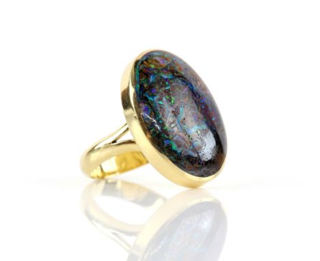 Contemporary boulder opal ring, an oval cut cabochon, 17 x 24mm, in 18 ct yellow gold, hallmarked Sheffield 2006, ring size S