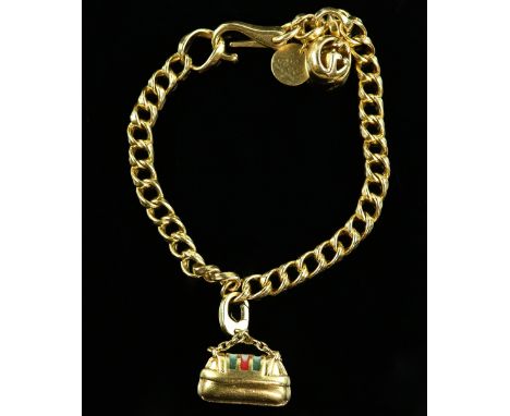 Gucci gold charm bracelet, fancy curb links, with round Gucci charm, spherical logo charm and a red and green enamel badge ch
