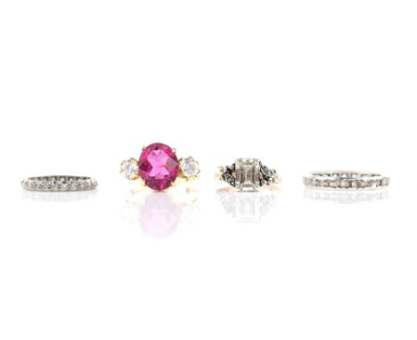 Four rings, one Swiss cut diamond full eternity, size K, a pink and white paste three stone, size N, both mounts testing as 1