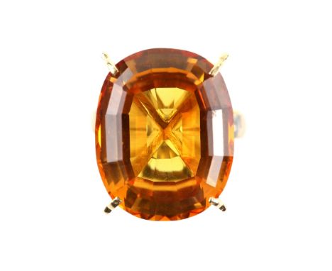 Synthetic orange sapphire cocktail ring, oval cut, 18.9 x 15.2cmm, four claw set, mount testing as 9 ct, ring size K9 ct weig