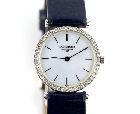 Longines ladies wrist watch, diamond bezel, mother-of-pearl face with baton markers, on Hirsch navy blue leather strap with L