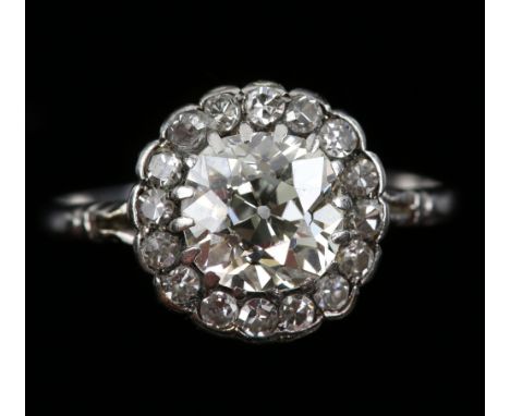 Early 20th C diamond cluster ring, central old cut diamond surrounded by Swiss cut diamonds, estimated total diamond weight 1