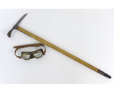A Swiss mountaineering ice axe 94 by 30cm, mid 20th century, together with a pair of Halcyon split glass driving goggles, BS4