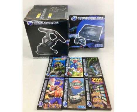 A Sega Saturn games console, with controller and original box, together with an A Saturn 'Arcade Racer' steering wheel contro
