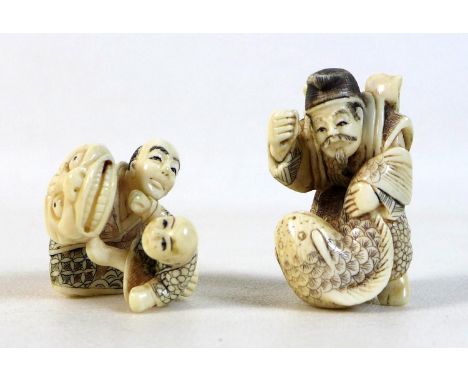 Two Japanese Meiji Period ivory katabori netsuke, one of a man playing with a child using a large face mask puppet, 3.2cm hig