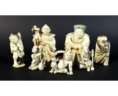 A group of Japanese Meiji period ivory figures comprising three netsuke, one of a gentleman with a sword and a child on his s