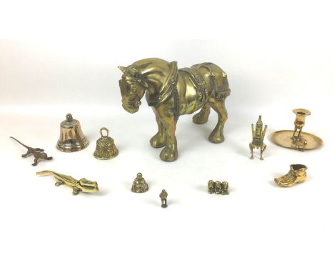 A collection of brass items, comprising a heavy cast brass shire horse figure, 34 by 14 by 25.5cm high, a chamberstick, a Bud