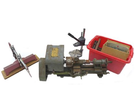 A group of five tools, comprising a GS mitre saw, with burgundy coloured handle, a large double handled saw with blade cover,