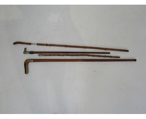 A sword stick, two swagger sticks including bamboo and a walking cane (4) 