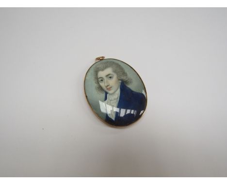 An early 19th Century miniature on ivory of young gentleman in blue jacket, attributed to Richard Cross, set in yellow metal 