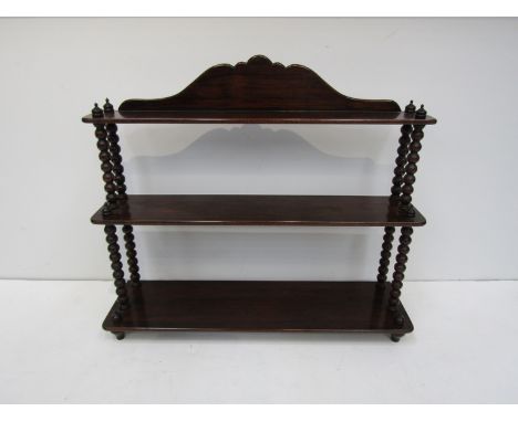 A set of early 19th Century heavy Cuban mahogany graduated three-tier wall shelves with bobbin-turned uprights, 76.5cm wide