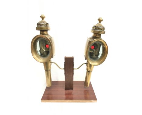 A pair of Victorian brass carriage lamps with bevelled glass to two sides and small red rear lens, mounting bracket to side. 