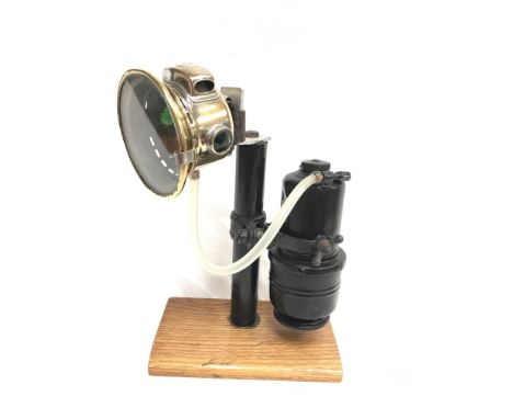 Lucas Calcia Cadet bicycle lamp, lens diameter 8.5cm, mounted on plinth.