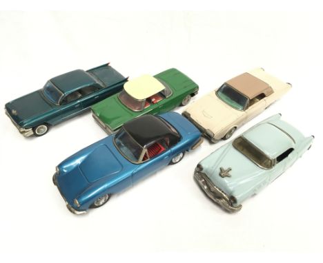 Five Japanese tinplate cars: Bandai Cadillac (l. 20.5cm), Ford Thunderbird (l. 20.5cm) and Lotus Elan (l. 21cm); Ichiko clock