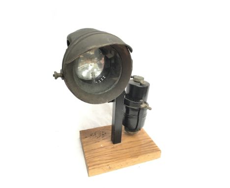 Nirona acetylene bike lamp with clear glass lens, diameter 10.5cm. Mounted on display plinth. 