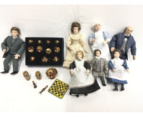 Seven 1/12th scale doll's house dolls: 2 x maid; 2 x children; mother; father; grandfather. Together with a selection of porc