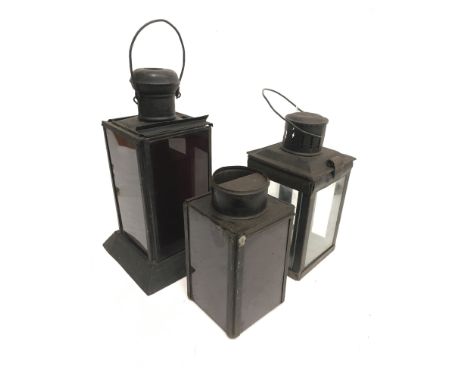 Hand-held lantern with three red glass slides to sides, height 30cm (inc. handle). Together with a smaller example with three