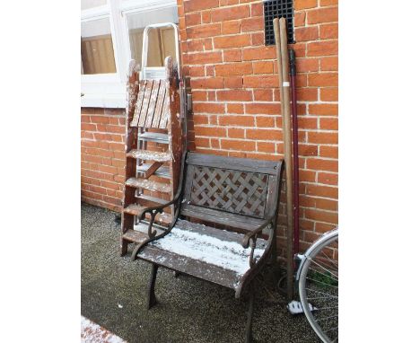 A cast iron and wooden garden chair, tools, a vintage step ladder etc