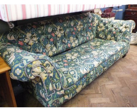 A Victorian style florally upholstered three seater Chesterfield sofa