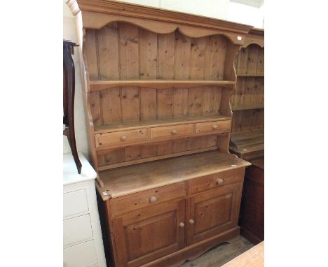 A light pine two drawer kitchen shelf back dresser