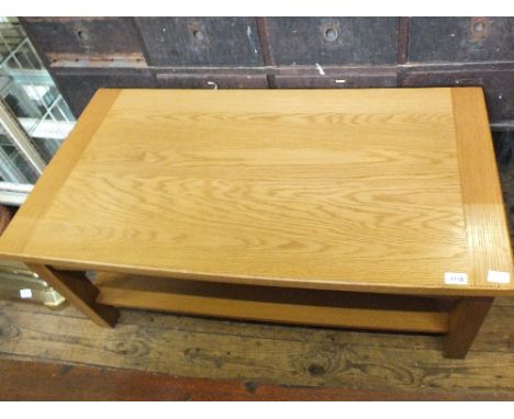 A light oak coffee table with shelf below, length 42 1/2"
