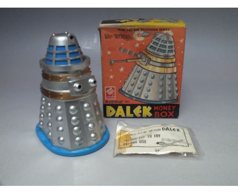 A RARE CODEG DR.WHO DALEK MONEY BOX, circa 1965, silver, gold and blue plastic body, guns and instruction leaflet still in se