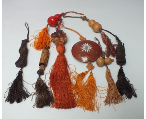 FOUR ORIENTAL CARVED WOODEN FIGURAL TOGGLES, together with three double gourd shaped examples and circular red enamel example