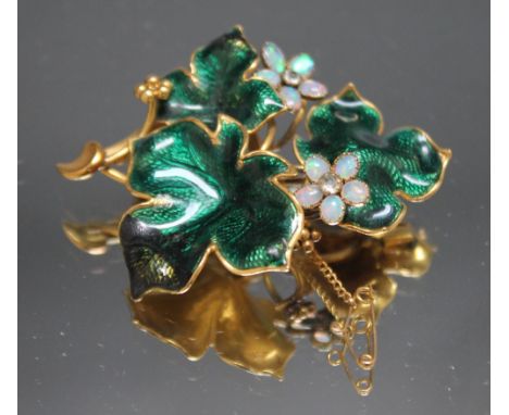 A YELLOW METAL AND ENAMEL GEMSET MEMORIAL BROOCH, the yellow metal frame with green enamel embellishment to the leaves, the t