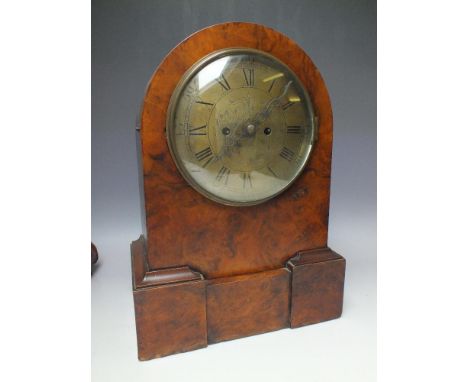 AN ANTIQUE DOMED WALNUT CASED TWIN FUSEE MANTEL CLOCK, the brass dial with Roman numerals and central engraved detail, key,  