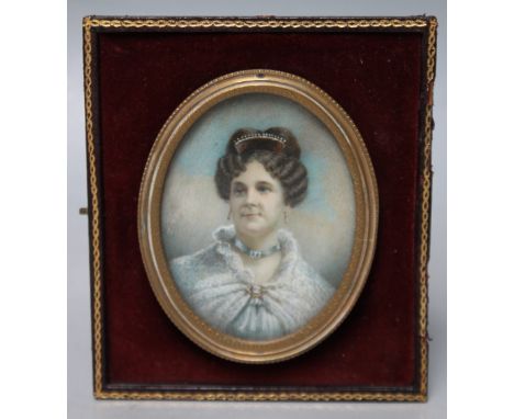 A 19TH CENTURY OVAL PORTRAIT MINIATURE ON IVORY OF A WOMAN WITH HAIR COMB AND SHAWL, unsigned, framed and glazed, 6 x 4 cm