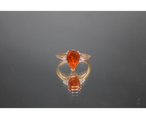 A HALLMARKED 9 CARAT GOLD RING, set with a pear shaped fire opal type stone, ring size S