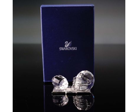 This retired Swarovski Crystal Memories American Football Trophy figurine showcases a faceted clear crystal football and helm