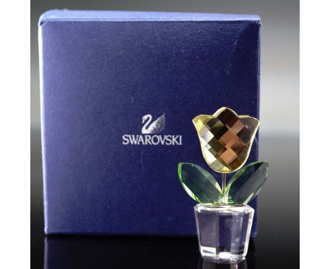 This exquisite Swarovski Crystal figurine features a delightful yellow tulip, crafted with precision-cut faceted crystal peta