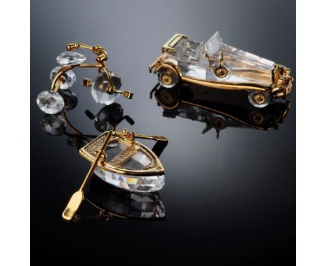 Set of three Swarovski Crystal Memories figurines featuring a tricycle, vintage automobile, and row boat, each crafted in cle