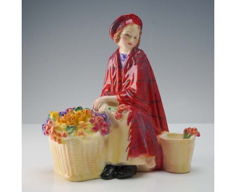 Crafted from fine bone china in England by Royal Doulton, Bonnie Lassie HN1626 portrays a seated flower girl adorned in a red