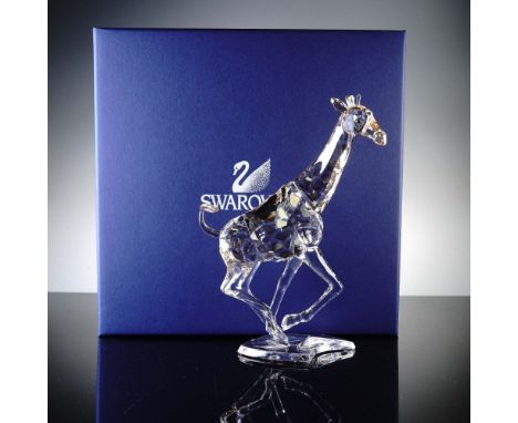 This dazzling Swarovski Crystal Running Giraffe figurine captures the elegant motion of the world's tallest animal with excep