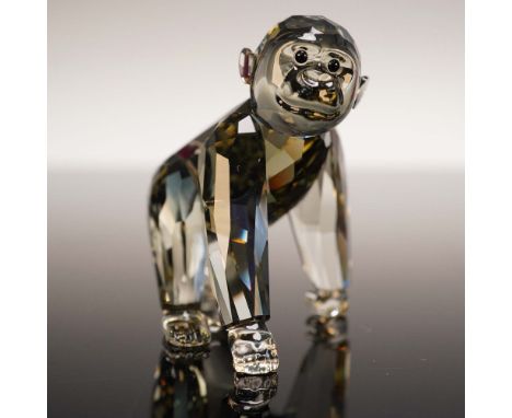 Presented here is a Swarovski Crystal Gorilla Cub, an endearing and masterfully crafted figurine. Made from faceted Black Dia