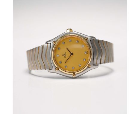 Swiss Ebel Wave wrist watch featuring a stainless steel construction with gold-tone accents. The round case houses a gold-ton