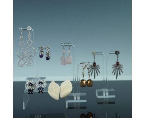 Collection of seven pairs of vintage pierced earrings in an array of materials and decorative styles. Included is a pair of s