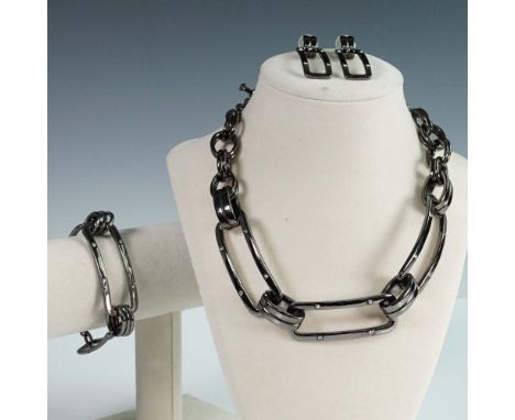 An oxidized silver-tone metal finish, featuring coordinated chain link designs with clear rhinestone accents. The collection 