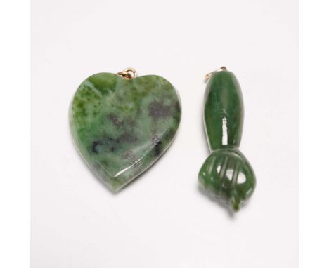 This lot includes two carved green jade pendants, each fitted with a small metal loop for suspension. The first pendant is sh
