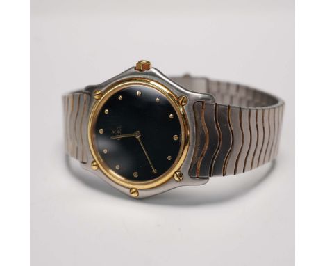 This is a stainless steel and gold tone wristwatch by Ebel, crafted in Switzerland. The watch features a black dial accented 
