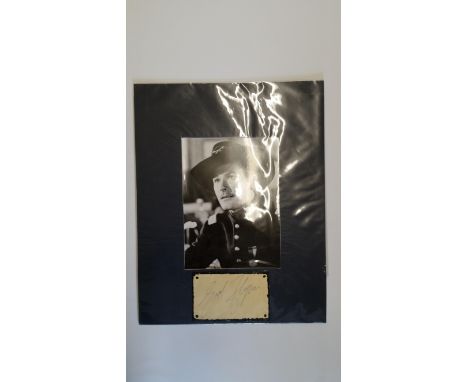 CINEMA, signed album page by Errol Flynn, overmounted beneath photo, half-length in character wearing army uniform, 10.5 x 13