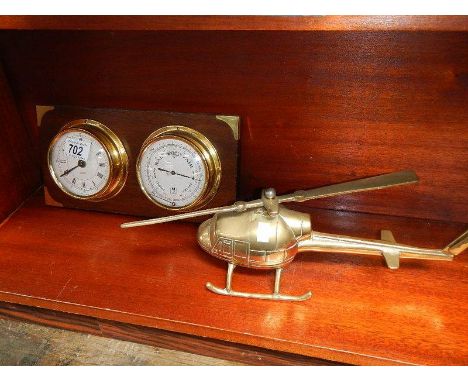 A solid brass helicopter and a ships style clock barometer.