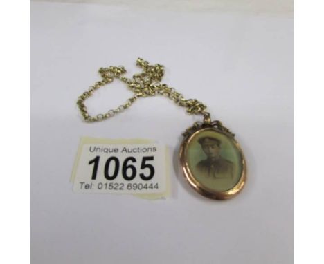 An early 20th century first world war period sweetheart locket of an young man in officer's uniform, ornate goldwork, 9ct, an