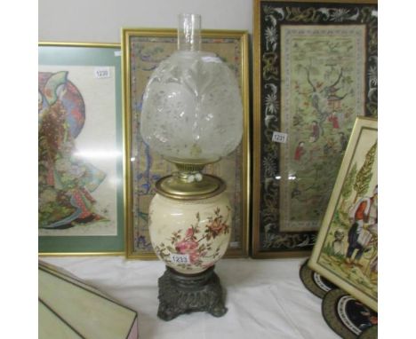 A Victorian pottery and brass oil lamp.