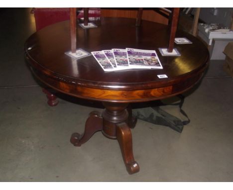 A round mahogany tripod tea / dining table